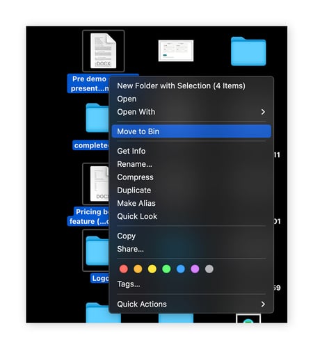 Highlighting multiple files on desktop and moving them to Bin on macOS.