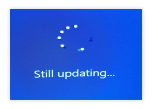 Windows update window with circling activity dots.